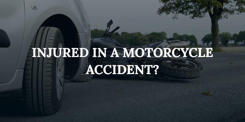 car stopped in front of a motorcycle laying on its side with the caption: "Injured in a motorcycle accident?"